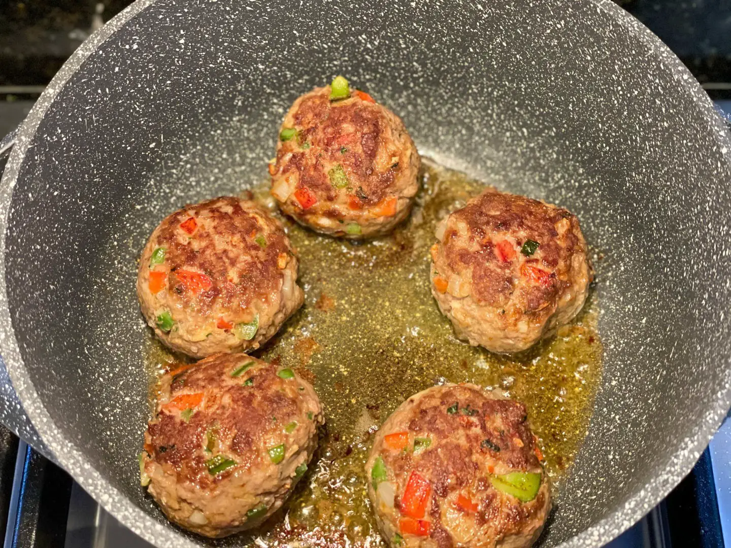 Photo of browning Cuban albondigas in a Dutch oven.