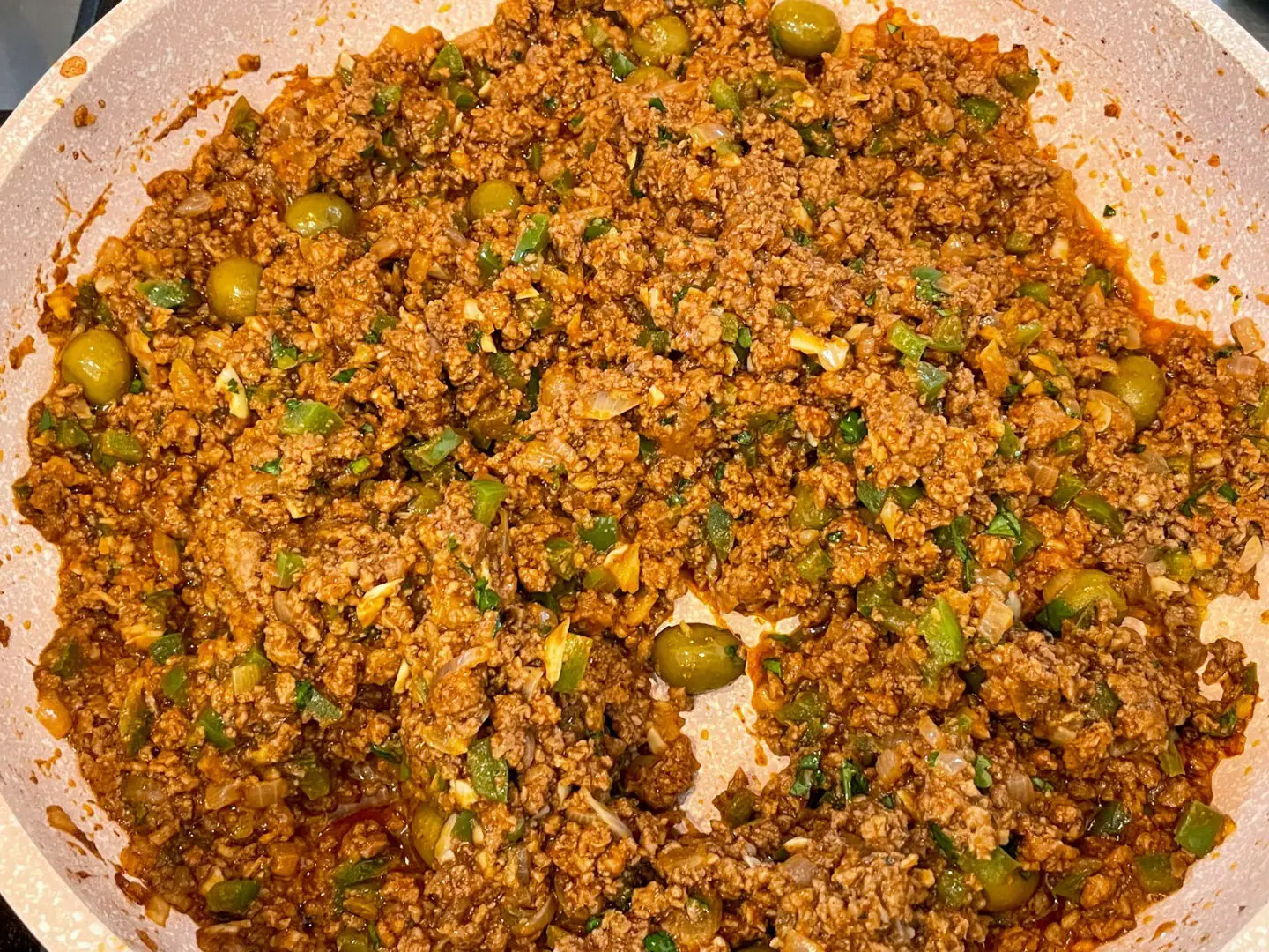 Cooked picadillo in pan.