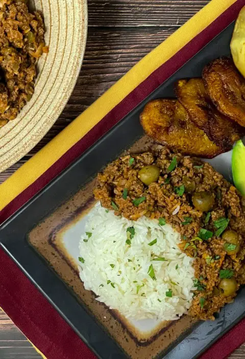 Cuban picadillo pictured with sides.