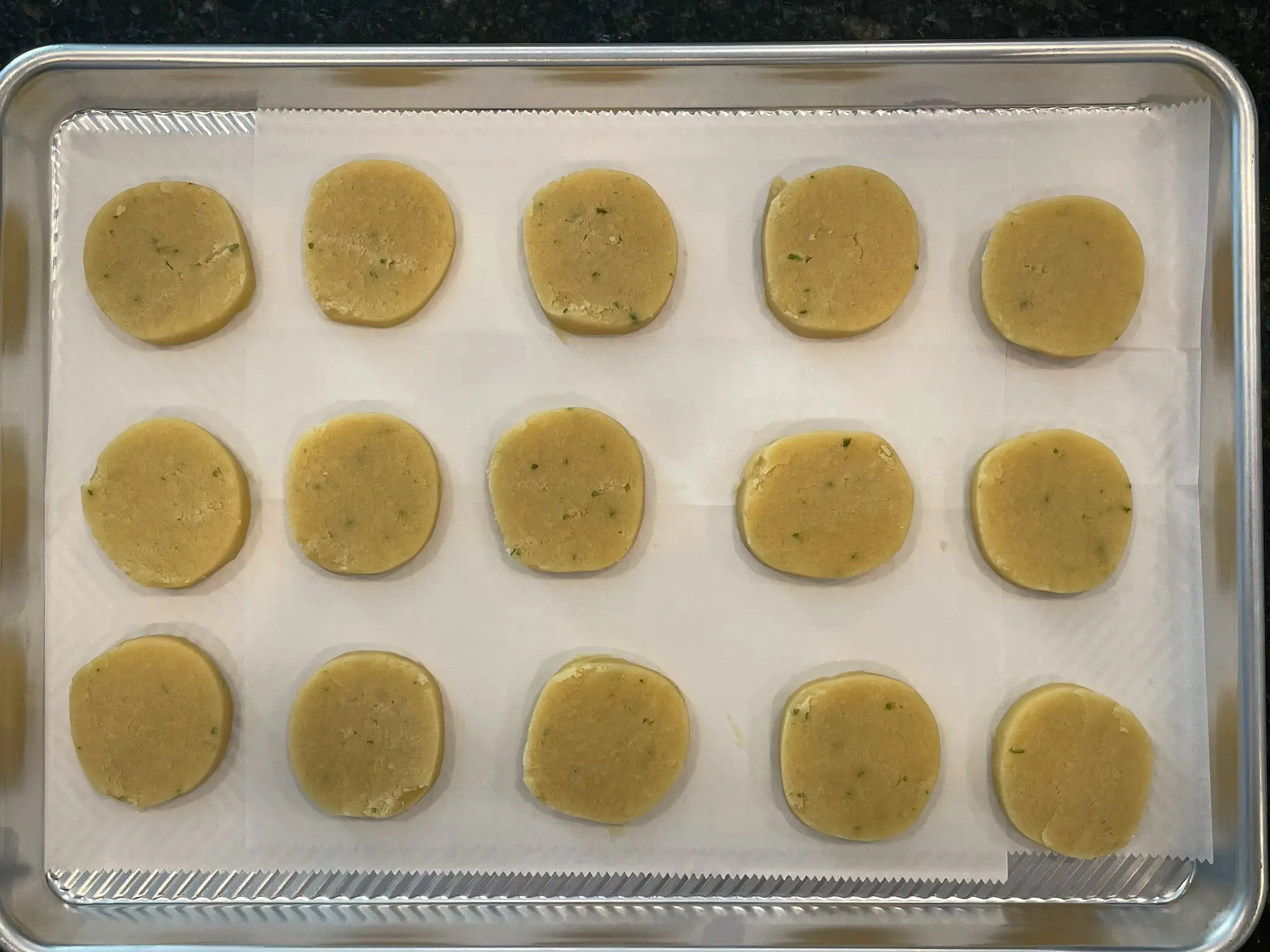 Uncooked torticas de moron on a cookie sheet.