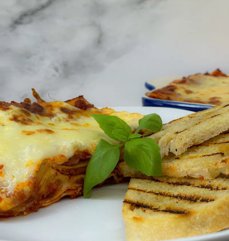 Abuelo’s lasagne served with garlic bread.