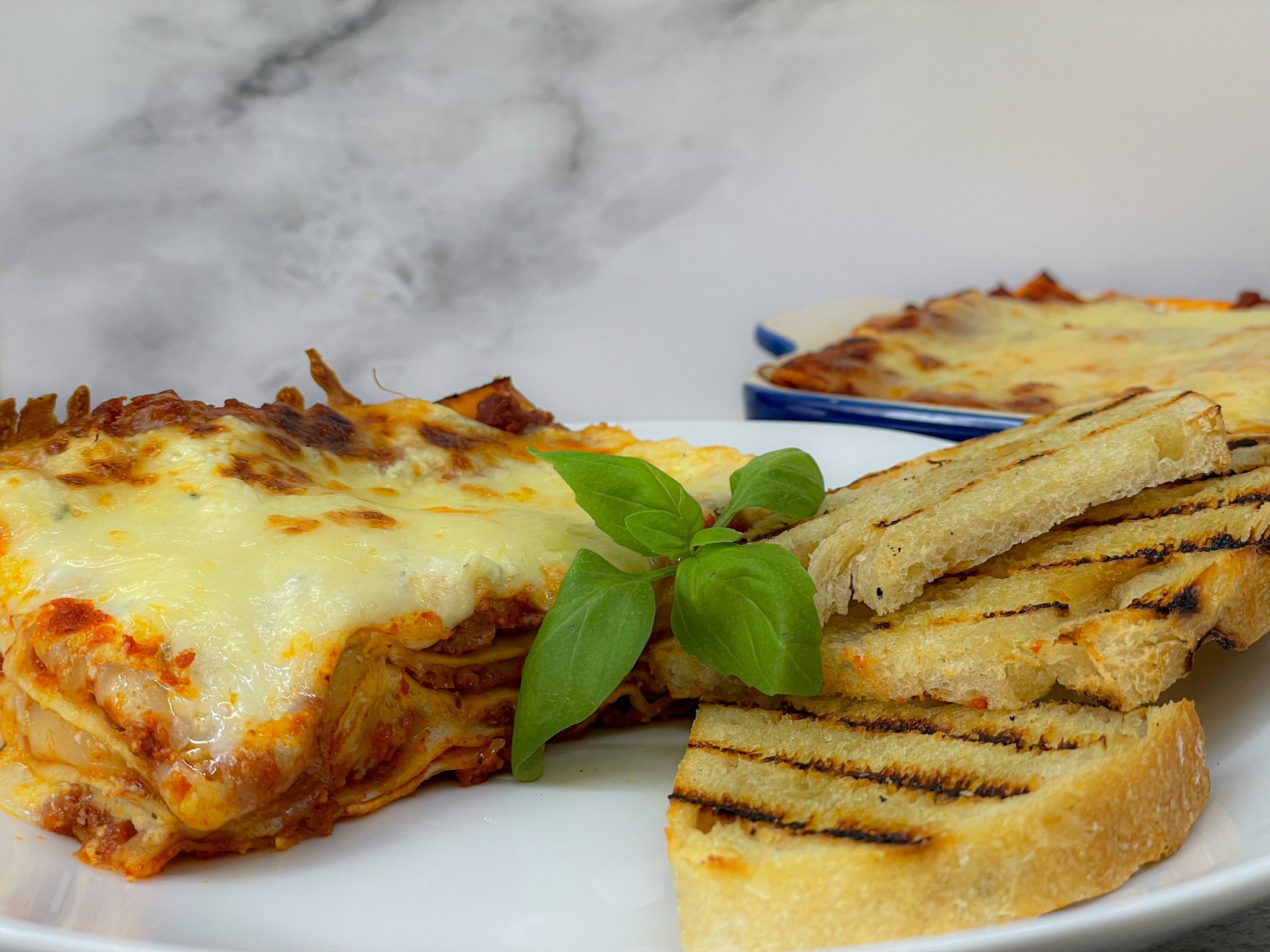 Abuelo’s lasagne served with garlic bread.