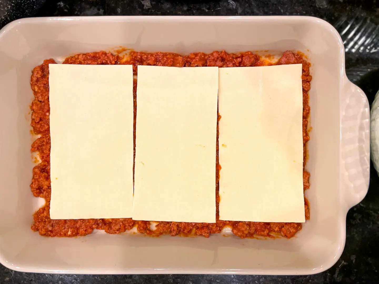Lay out oven ready lasagne sheets.