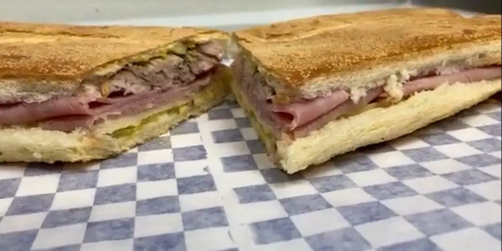 A Cuban sandwich cut in half from The Cuba Station.