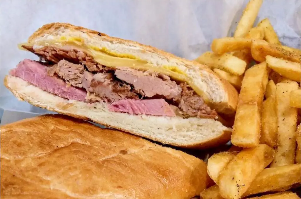 A Cuban sandwich cut in half served with French fries from the Havana Cafe.
