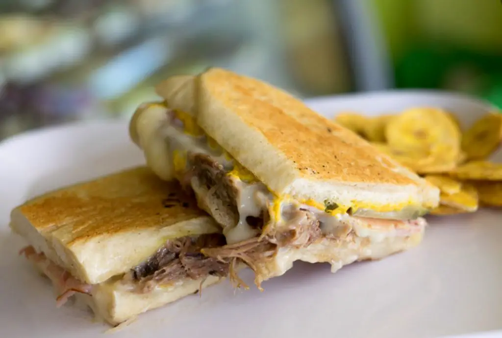 A Cuban sandwich cut in half served with plantain chips from Azucar restaurant.