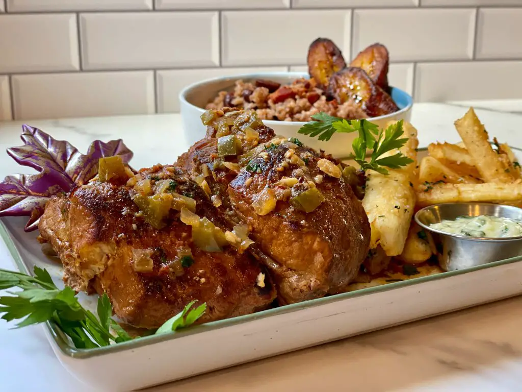 Costillitas de fricase, baby back ribs fricassee served with fried yuca and red bean congri and maduros.