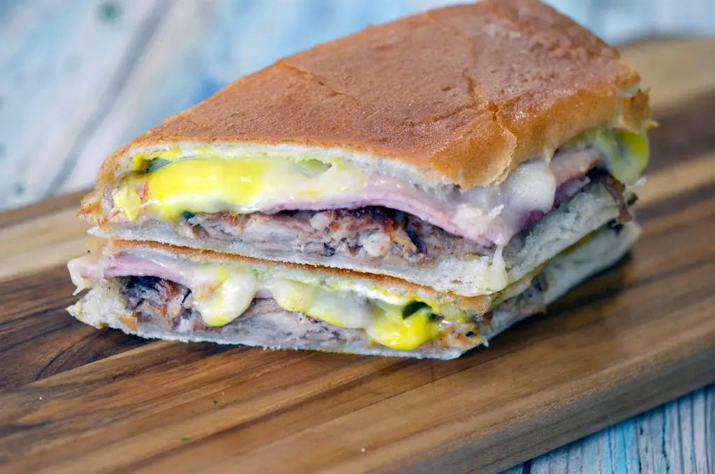 A Cuban sandwich from Tina's Cuban Cuisine restaurant on a wooden board.