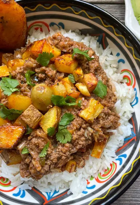 Picadillo con Papas served over a bed of rice.