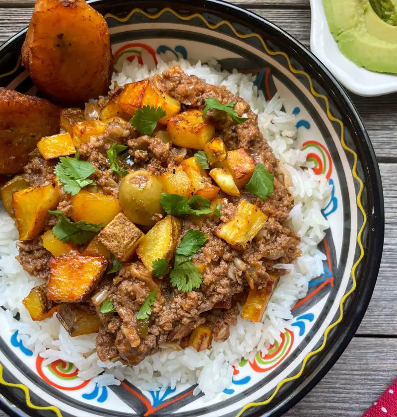 Picadillo con Papas served over a bed of rice.