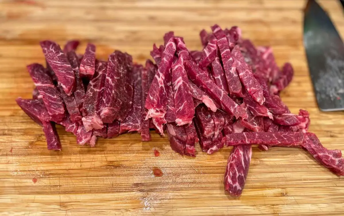 Cut steak into strips.