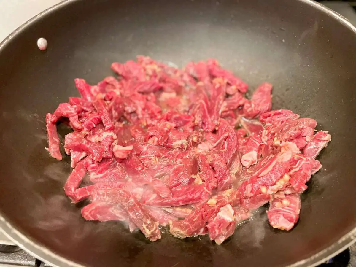 Cook steak strips on medium high to high heat in a wok.