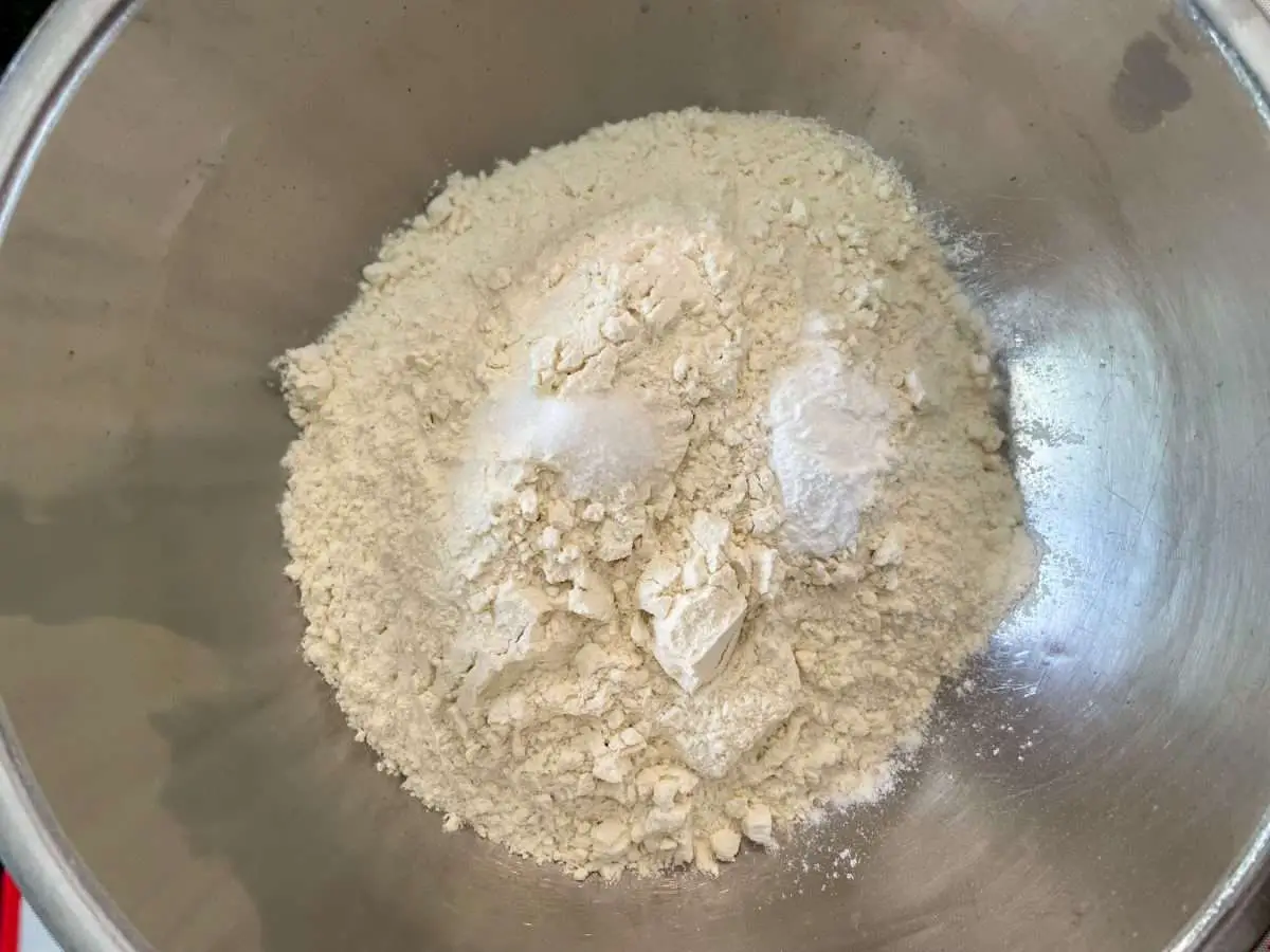 Flour, salt and baking powder in a bowl for making empanada dough.