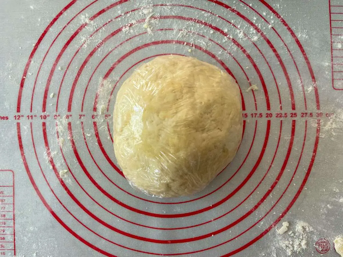 After dough ingredients are mixed and kneaded wrap dough in plastic wrap and let rest for 30 minutes.