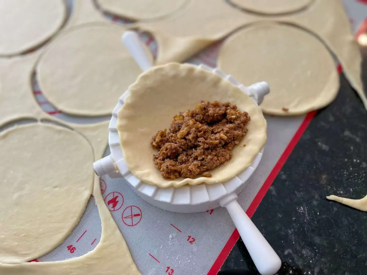 Using a hand pie mold to make larger empanadas.