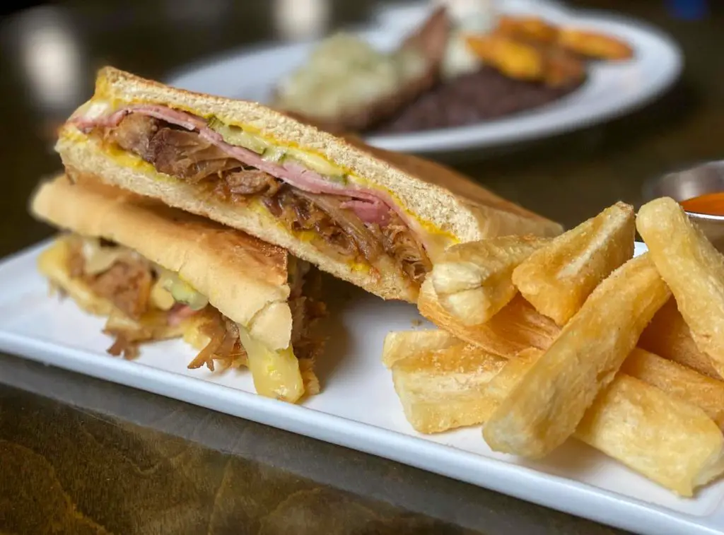 A Cuban sandwich and yuca fries served at Chao Pescao restaurant.