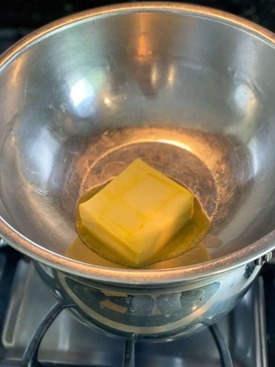 Melting butter over a double broiler. The first step in making dulce de leche brownies.