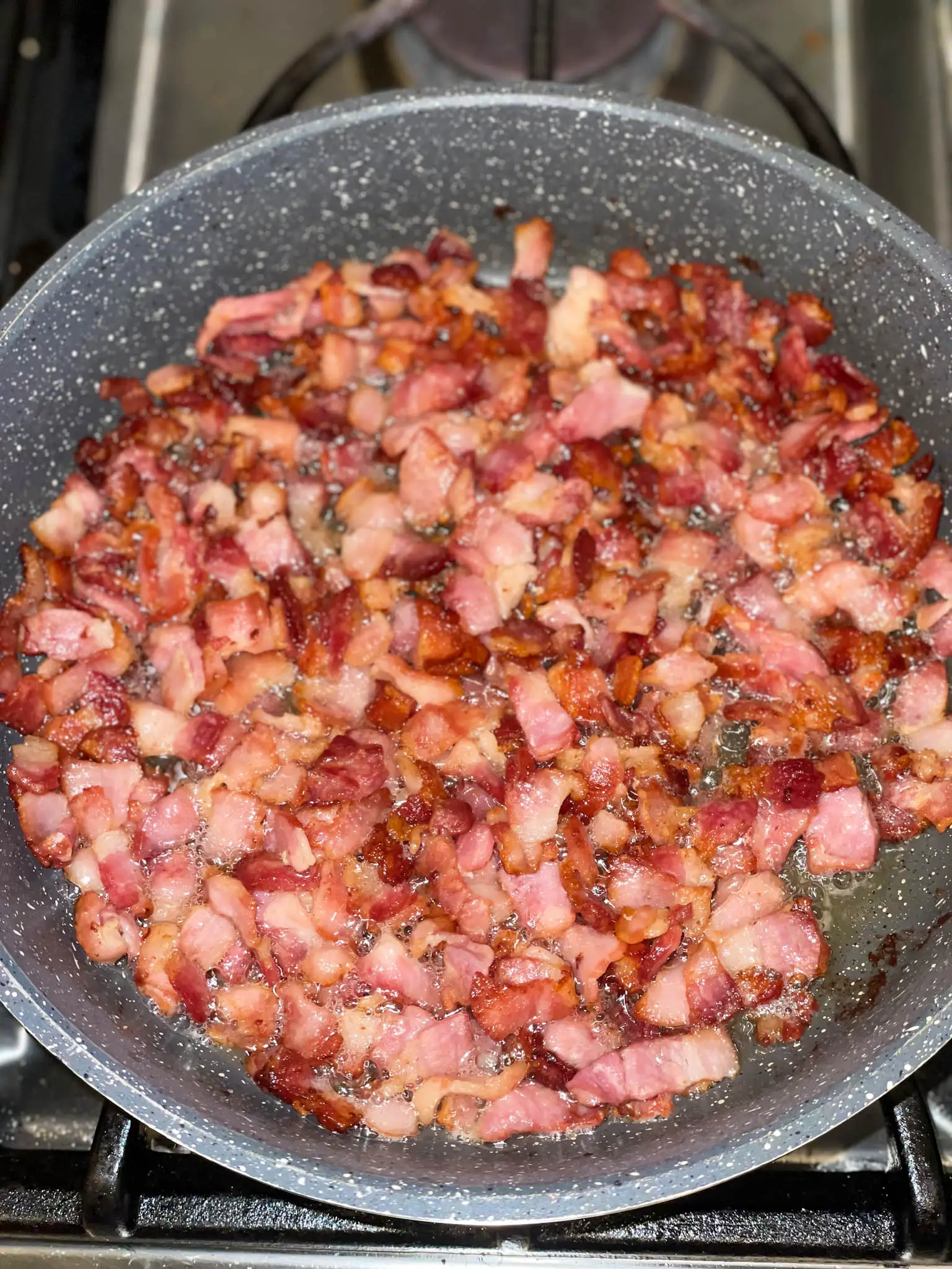 Cooking bacon for red bean Congri in a sauté pan.