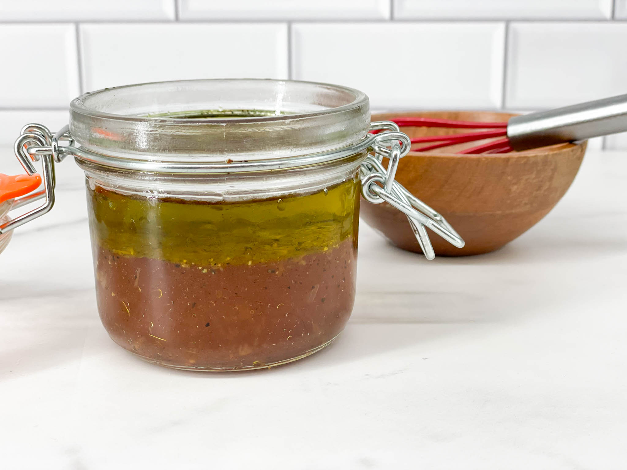 A vinaigrette made with olive oil, red wine vinegar and seasoning for a fresh salad.