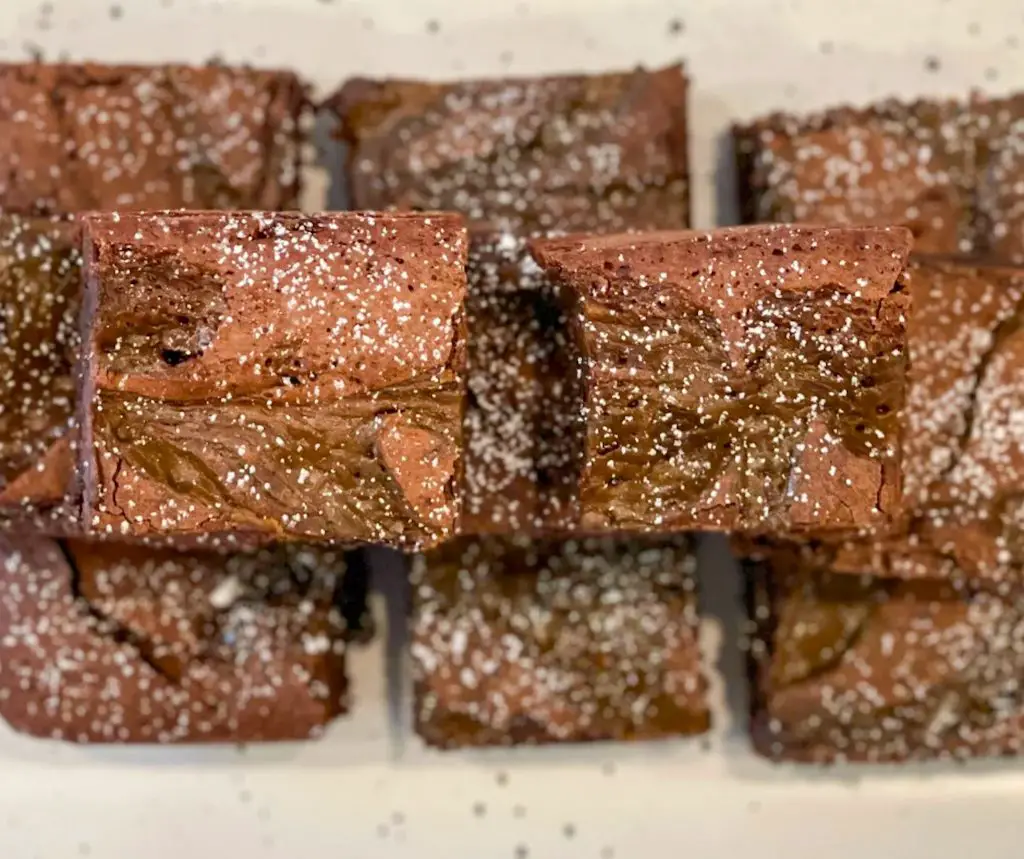 Dulce de leche brownies stacked on a plate.